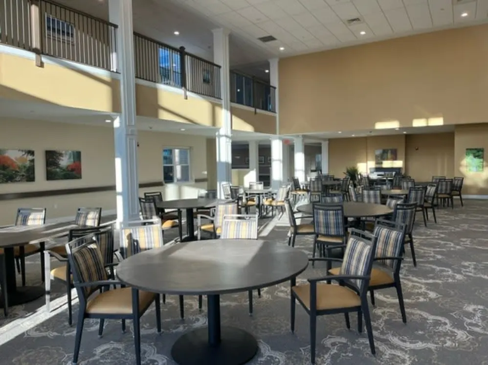 Spacious dining hall with round tables and balcony