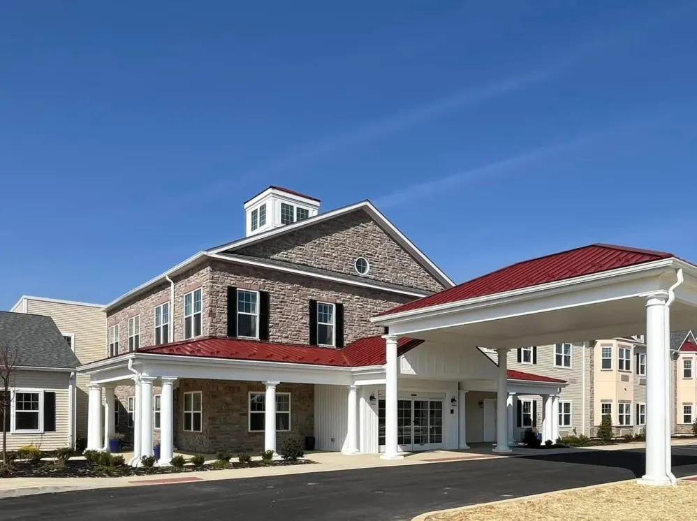 Stone building with red roof and covered entrance