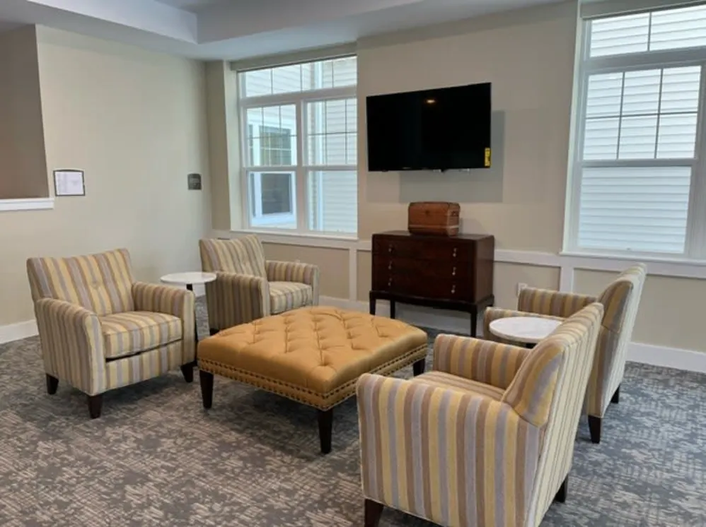 Cozy seating area with striped chairs and ottoman